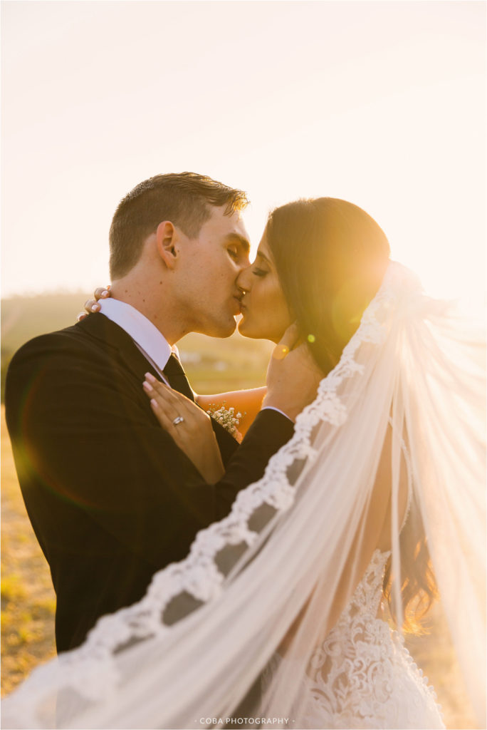 wedding at nooitgedacht estate couple kissing in sunset at nooitgedacht