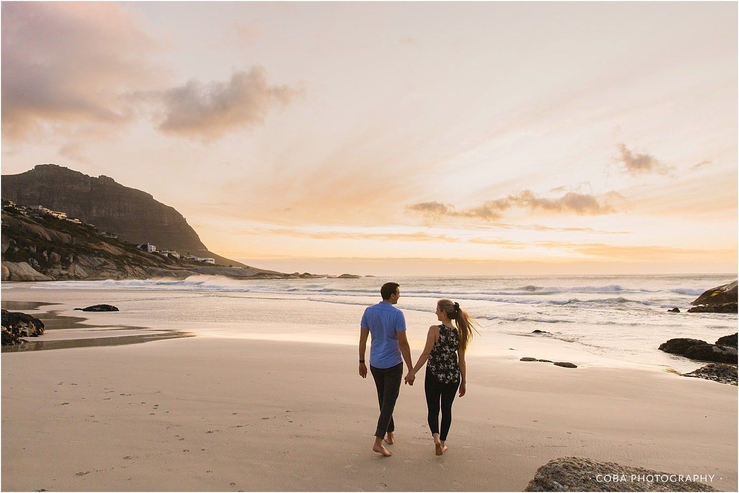 couple walking on beach at llandudno