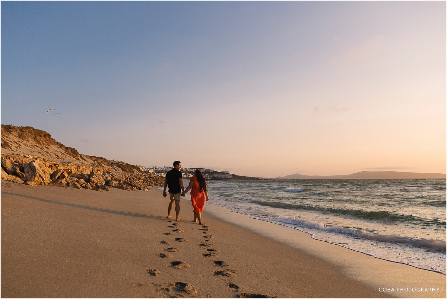 couple walking on beach langebaan