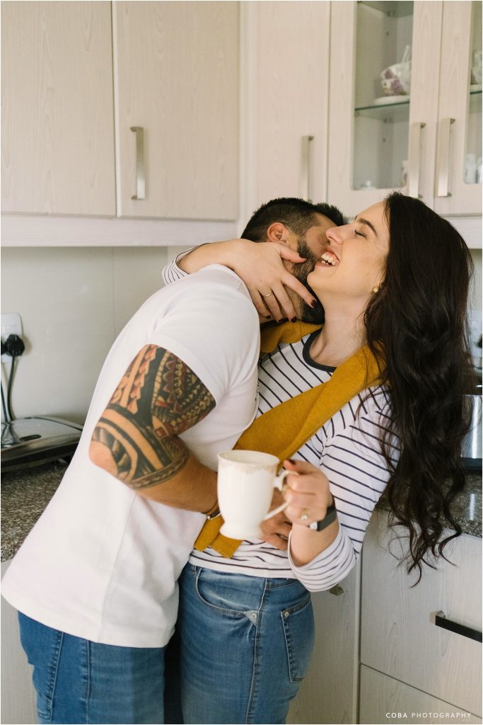 couple laughing with coffee - home couple photoshoot cape town