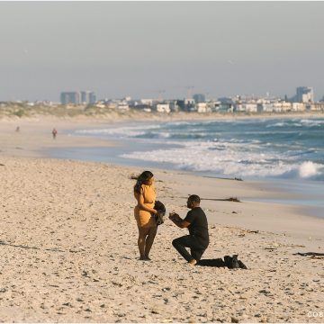 surprise proposal in cape town on dolphin beach