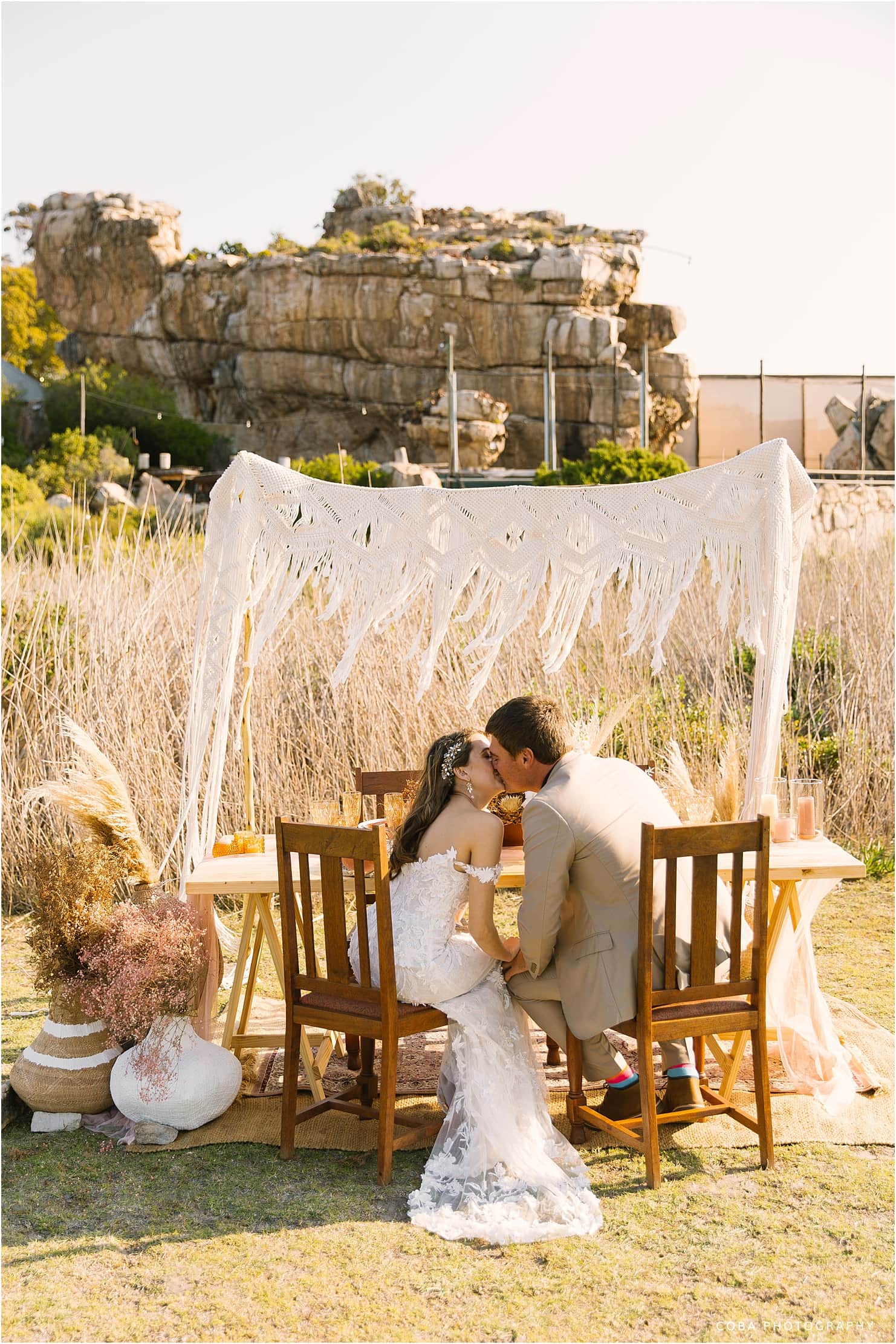 table setting in the vlei at bosduifklip with couple kissing - boho farm styled shoot