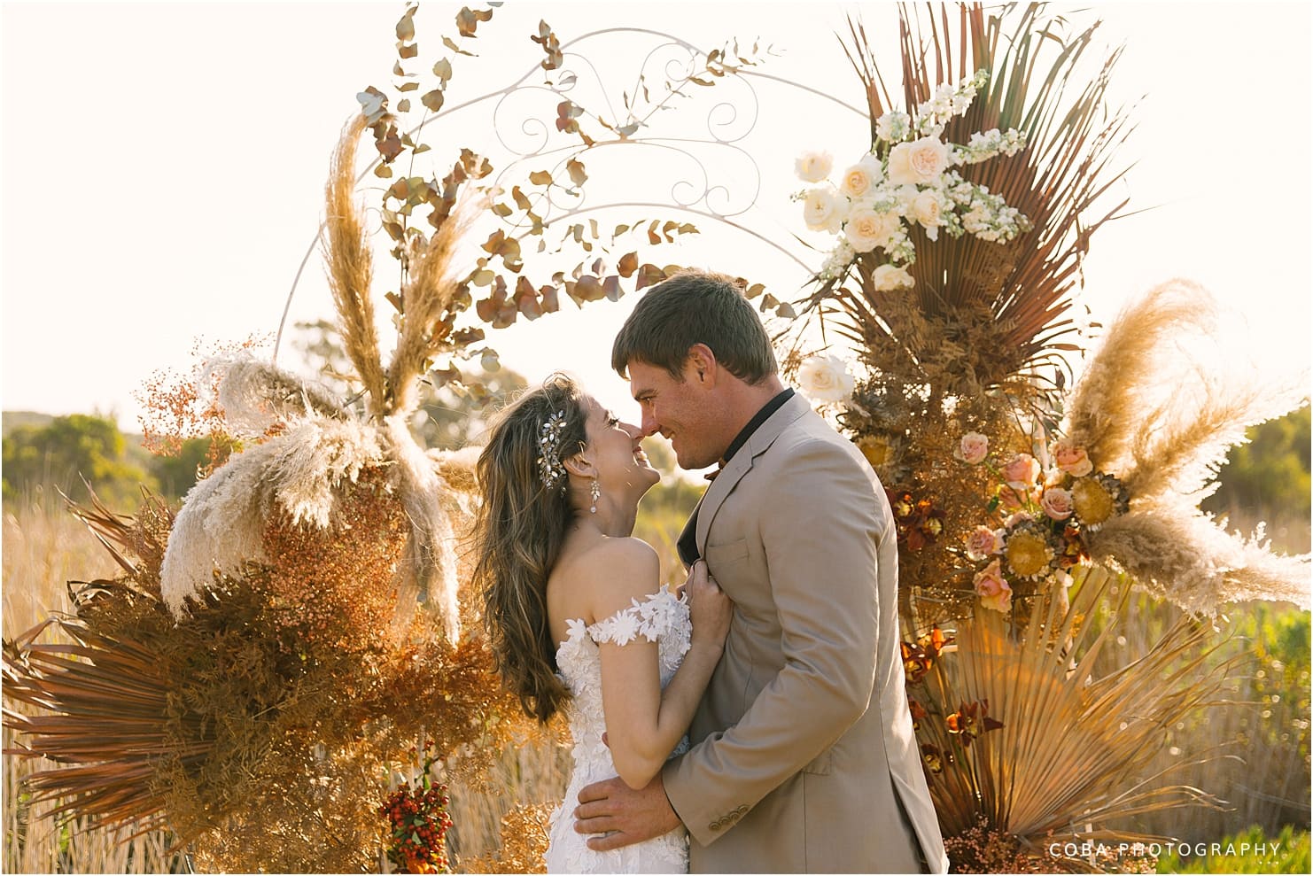 couple in front of wedding arch at bosduifklip - willem and sanel