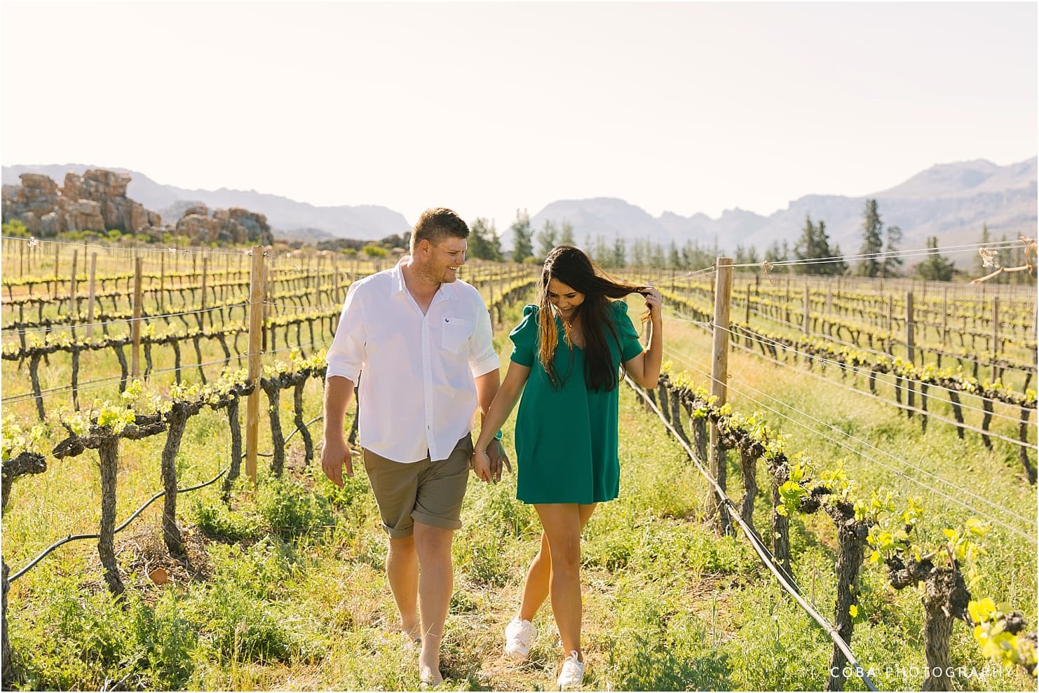 couple photos at cederberg wines - couple walking in vineyard