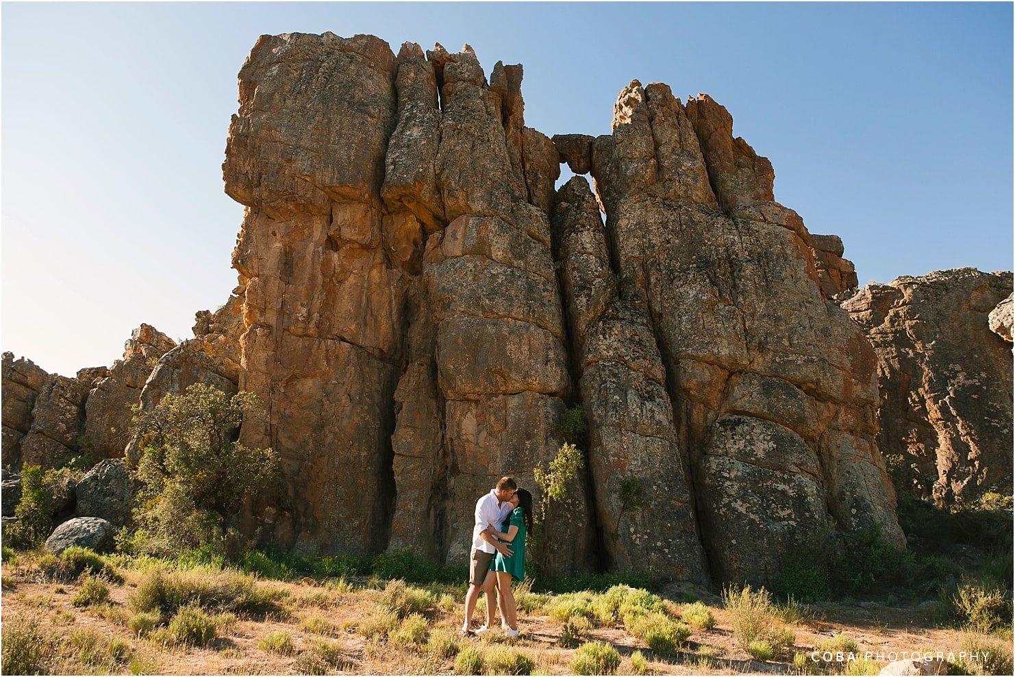 cederberg couple shoot at cederberg wines - couple in front of big rock formation