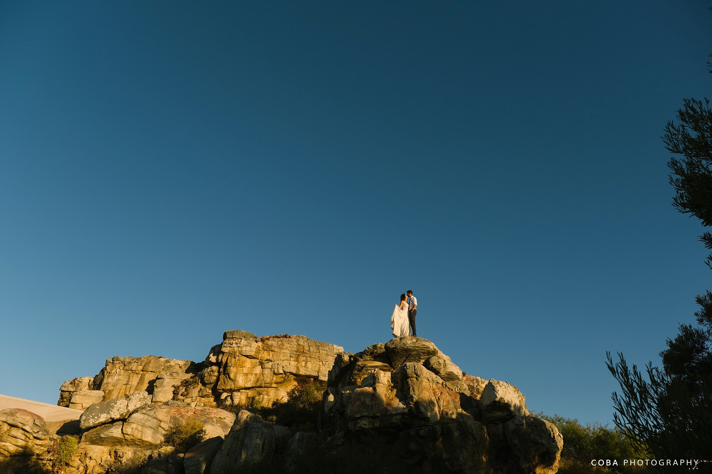 intimate wedding at bosduifklip couple standing on rocks at rustic wedding venue