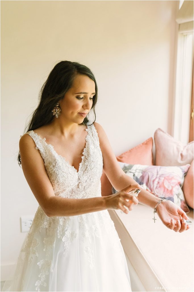 ida webster hair and make up - bride putting on perfume