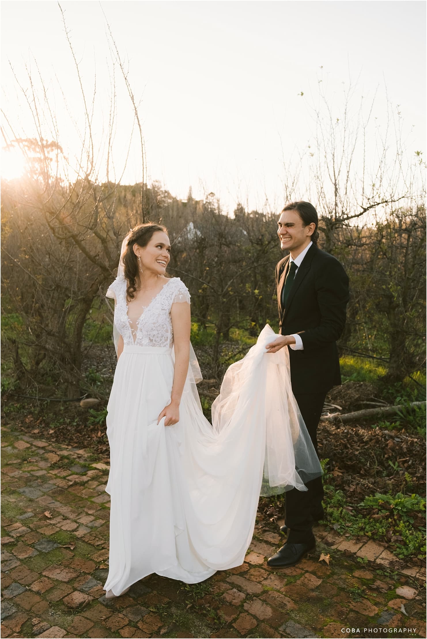brenaissance wedding - bride and groom walking in sunset