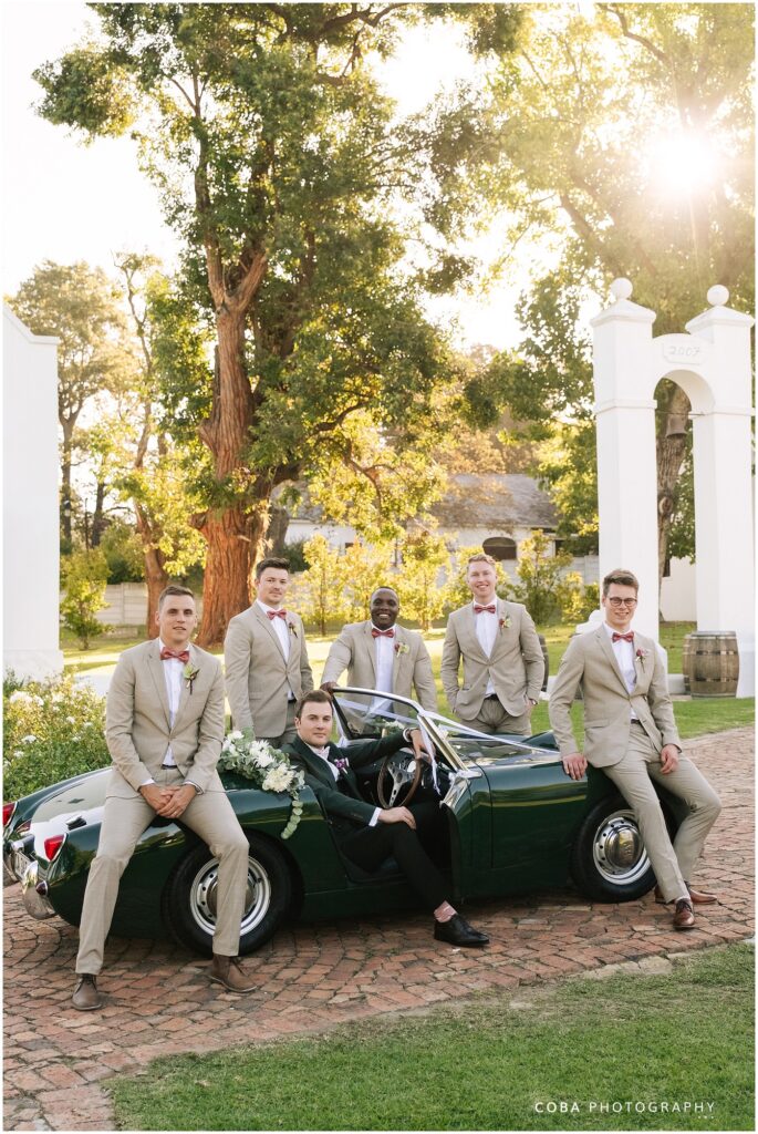 wedding at zorgvliet - groom and groomsmen with vintage green car