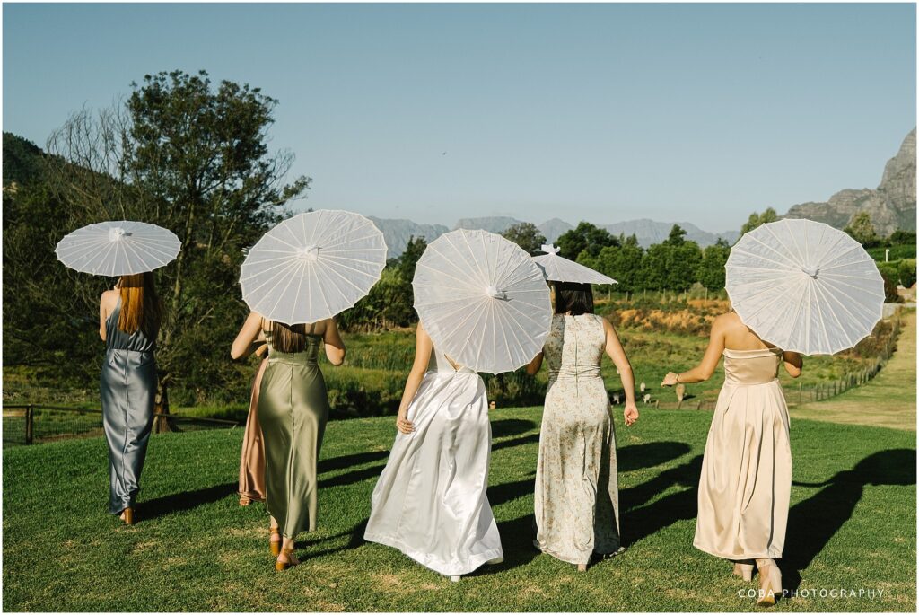 alluvia wedding venue  - bridesmaids with umbrellas