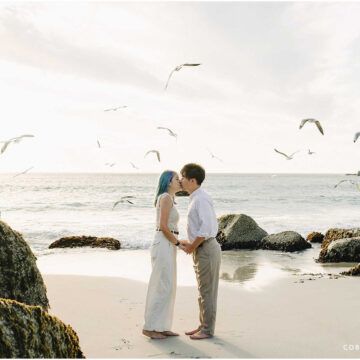 Engagement beach photo of Yutaro and Rei walking along Camps Bay shoreline at sunset
