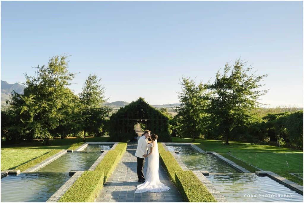 Belair Pavilion wedding couple kissing in front of chapel
