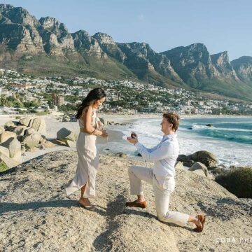 A romantic Maiden's Cove sunset proposal in Cape Town with the Twelve Apostles mountains in the background.